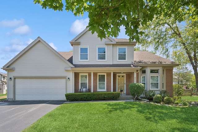 276 Stanton Dr, Buffalo Grove, IL 60089 - traditional-style home with asphalt driveway, brick siding, a front yard, a garage, and a porch
