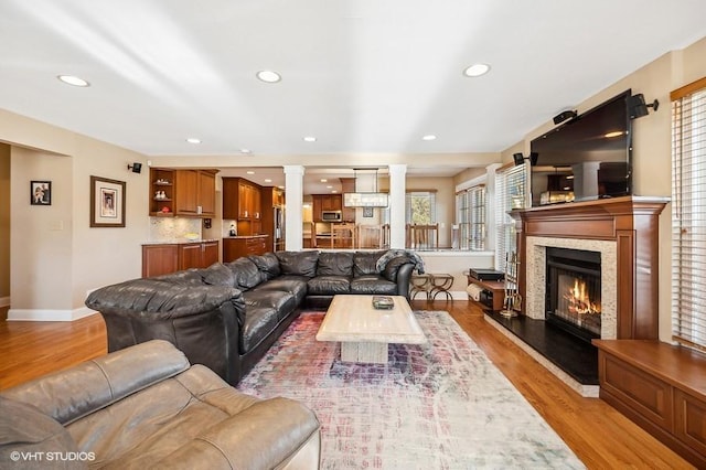276 Stanton Dr, Buffalo Grove, IL 60089 - living area featuring light wood finished floors, a premium fireplace, decorative columns, and recessed lighting