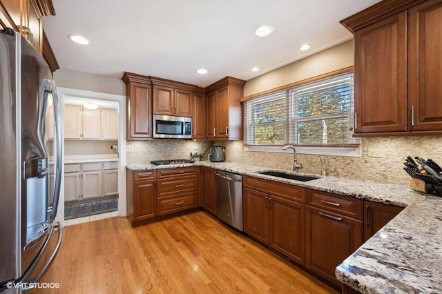 276 Stanton Dr, Buffalo Grove, IL 60089 - kitchen featuring appliances with stainless steel finishes, light wood-type flooring, light stone countertops, backsplash, and recessed lighting