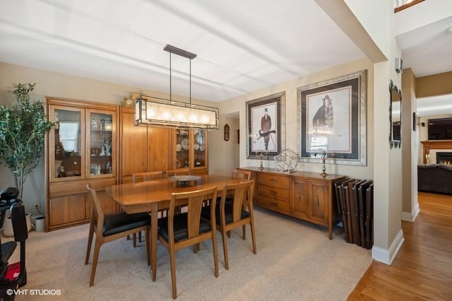 276 Stanton Dr, Buffalo Grove, IL 60089 - dining space with a lit fireplace and light wood finished floors