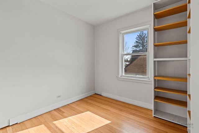 unfurnished room with wood-type flooring