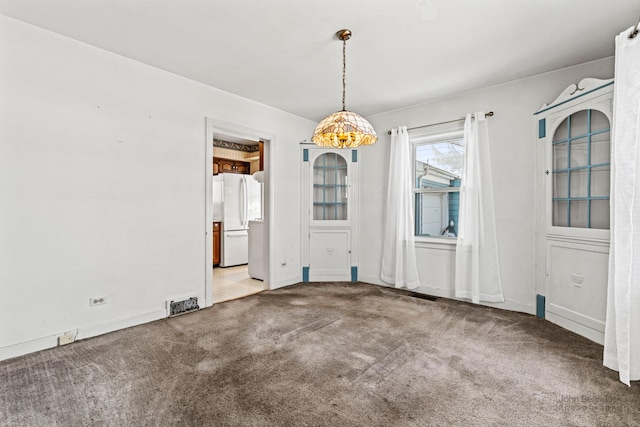 unfurnished dining area featuring carpet floors