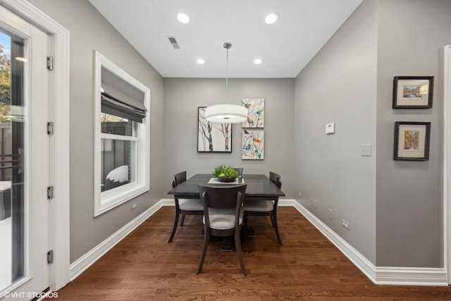 dining area with a healthy amount of sunlight and hardwood / wood-style floors