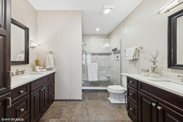 bathroom with vanity, toilet, and a shower with shower door