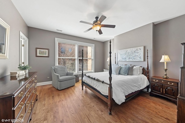 bedroom with ceiling fan and light hardwood / wood-style floors