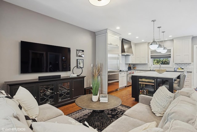 living room with wine cooler and light wood-type flooring