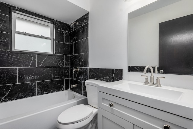 full bathroom featuring tile walls, tiled shower / bath combo, vanity, and toilet