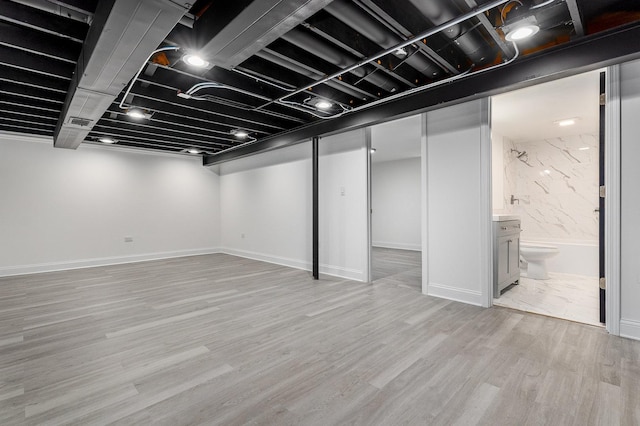 basement featuring light hardwood / wood-style flooring