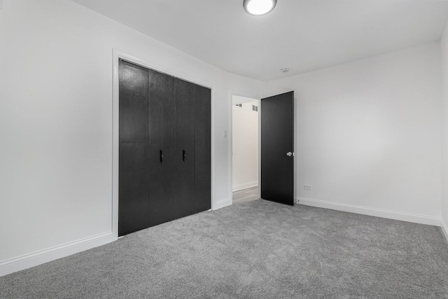 unfurnished bedroom featuring carpet floors and a closet