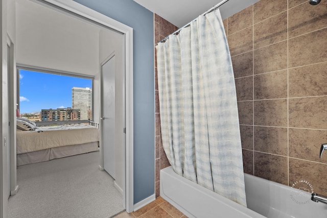 bathroom featuring shower / bathtub combination with curtain and tile patterned flooring