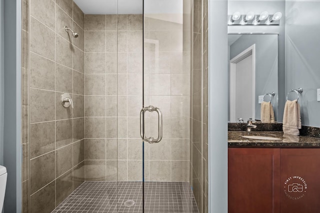 bathroom with walk in shower and vanity