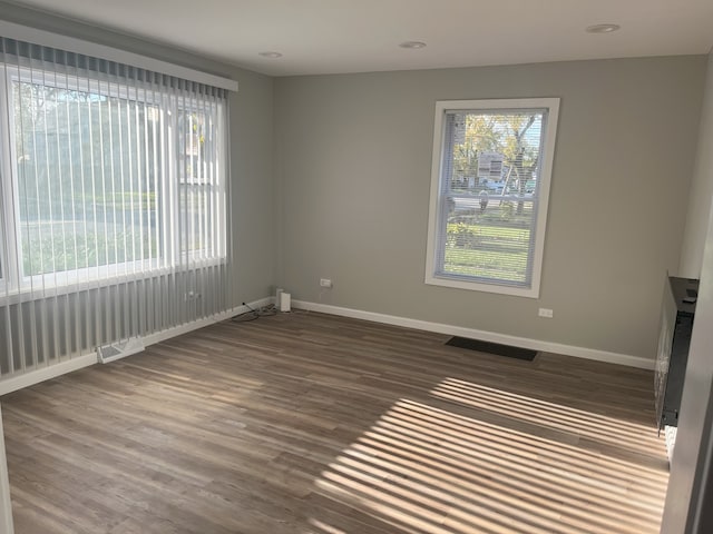 unfurnished room featuring dark wood-type flooring