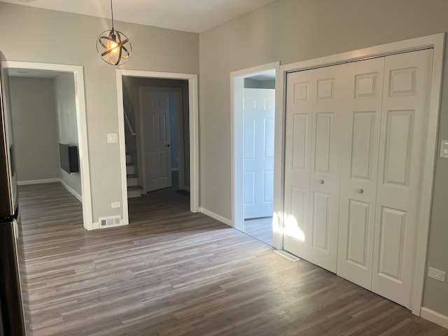 unfurnished bedroom featuring hardwood / wood-style floors and a closet