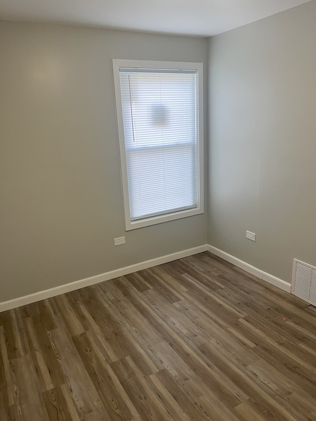 empty room featuring dark wood-type flooring