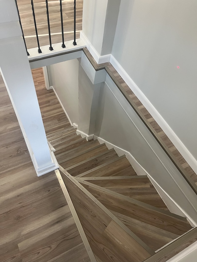 stairs featuring wood-type flooring