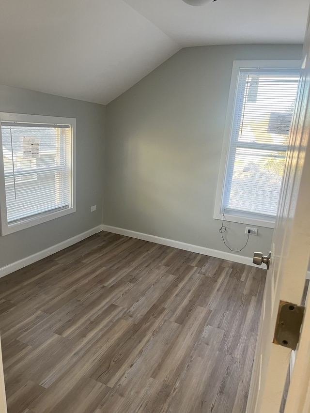 bonus room with dark hardwood / wood-style flooring and lofted ceiling