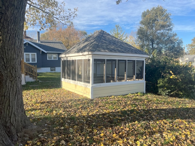 view of side of property featuring a sunroom