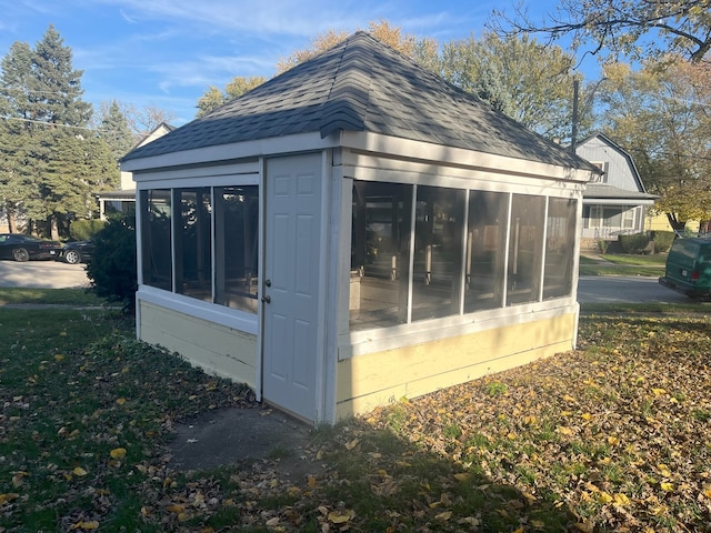 view of outbuilding with a sunroom