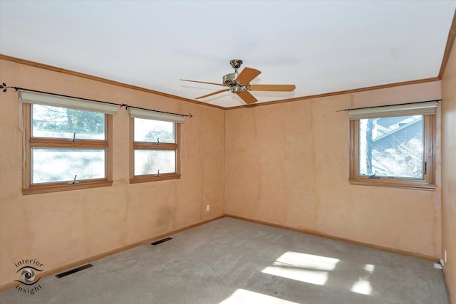 carpeted empty room featuring ornamental molding and ceiling fan