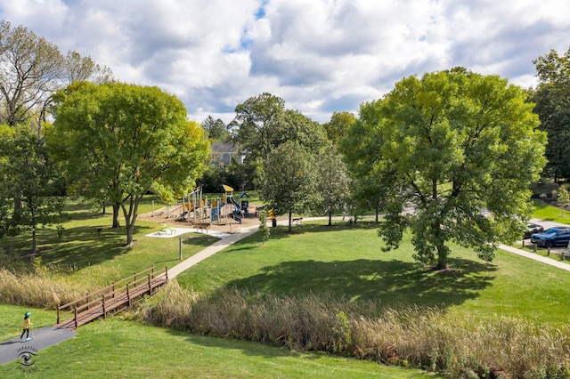 view of property's community featuring a playground and a lawn