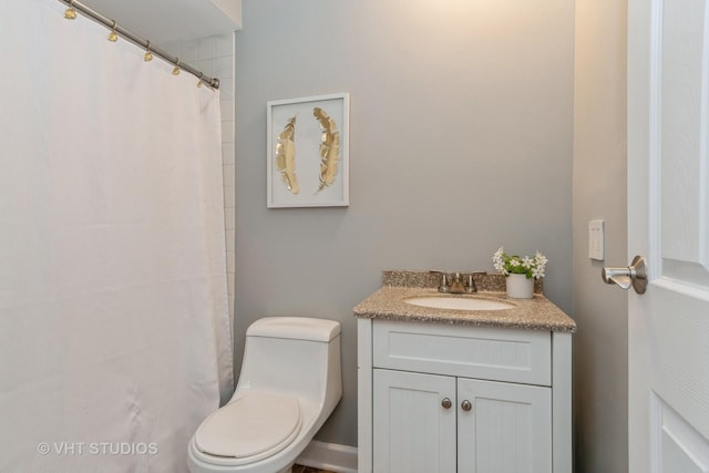 bathroom featuring vanity and toilet