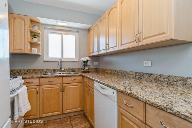 kitchen featuring white appliances, light stone countertops, sink, and light brown cabinets