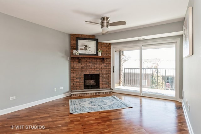 unfurnished living room featuring wood-type flooring, ceiling fan, and a fireplace