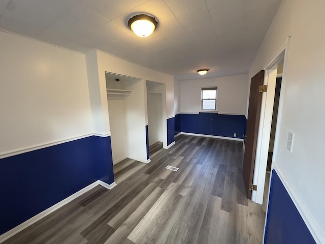 empty room with dark wood-type flooring