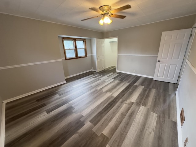 spare room featuring ceiling fan and dark hardwood / wood-style floors