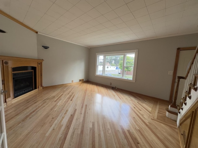 unfurnished living room with light hardwood / wood-style flooring and ornamental molding