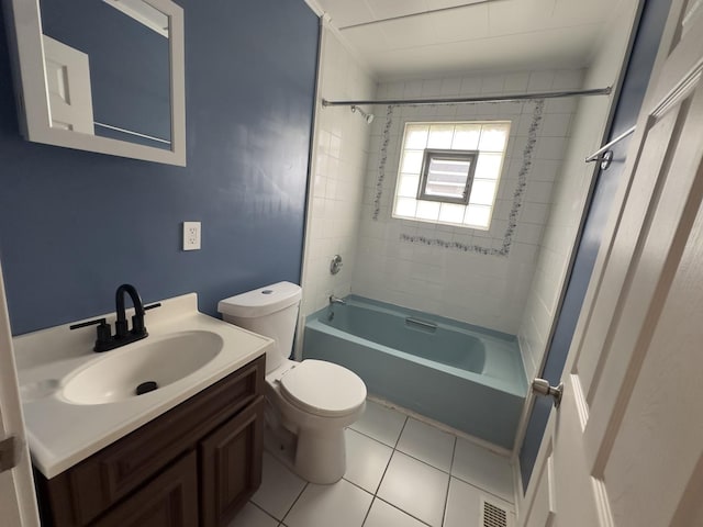 full bathroom featuring toilet, tiled shower / bath combo, tile patterned floors, and vanity