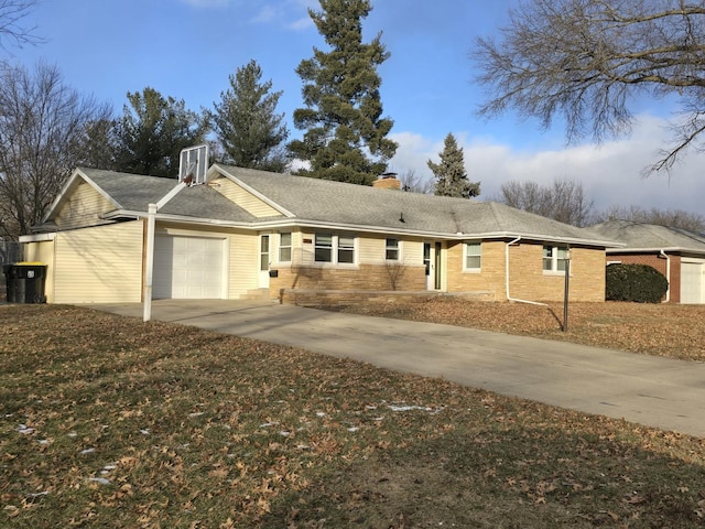 single story home featuring a garage and a front yard