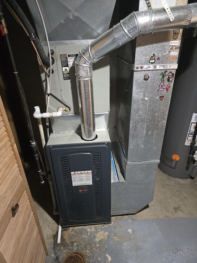 utility room featuring water heater