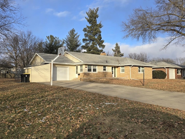 single story home featuring a garage and a front lawn