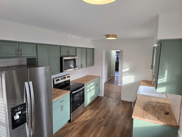 kitchen featuring dark hardwood / wood-style floors, wooden counters, green cabinetry, and appliances with stainless steel finishes