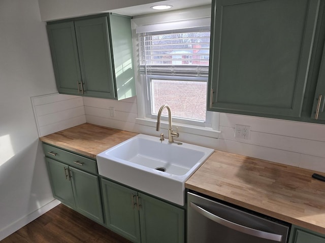 kitchen featuring stainless steel dishwasher, sink, and green cabinets