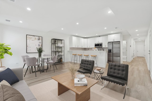 living room with light hardwood / wood-style flooring