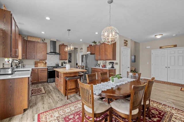 dining space featuring sink and light hardwood / wood-style flooring