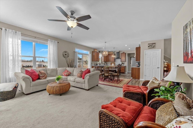 living room with ceiling fan and carpet floors