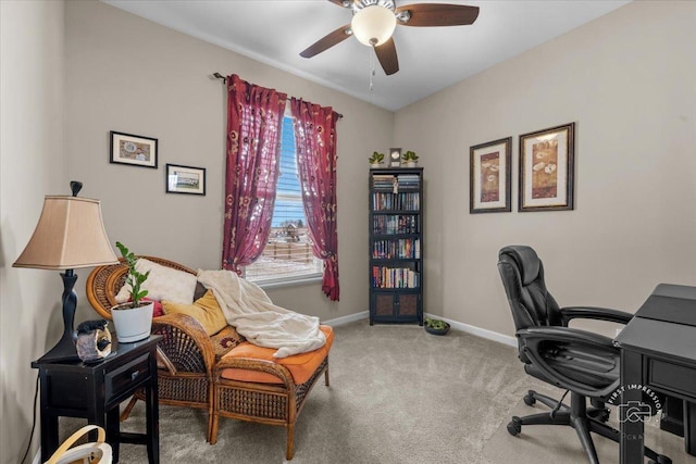 carpeted office space with ceiling fan