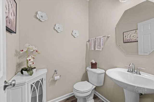 bathroom with sink, hardwood / wood-style flooring, and toilet