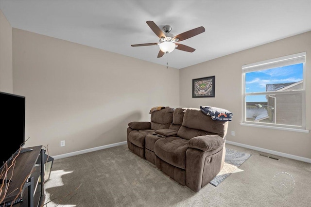 carpeted living room with ceiling fan