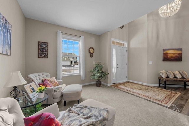 sitting room with carpet floors and a notable chandelier