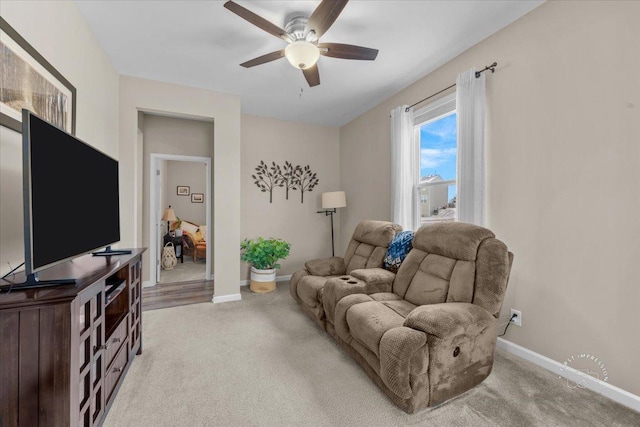 living room featuring ceiling fan and light carpet