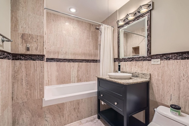 full bathroom featuring toilet, vanity, tile walls, tile patterned floors, and shower / bath combo