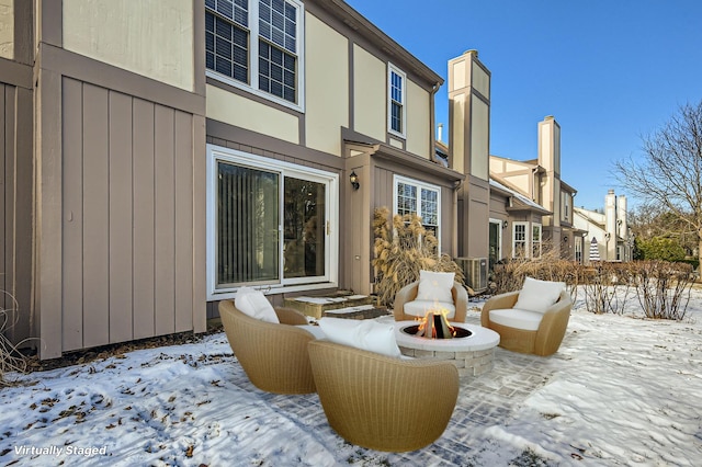 exterior space featuring central AC and an outdoor fire pit