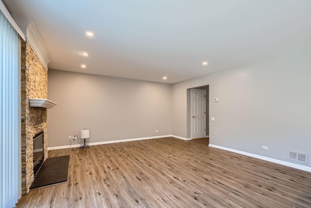 unfurnished living room featuring light hardwood / wood-style floors and a fireplace