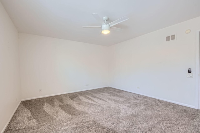 spare room featuring ceiling fan and carpet