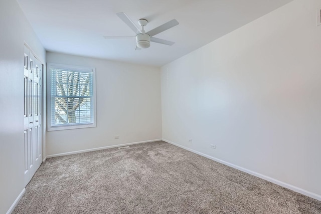 carpeted empty room with ceiling fan