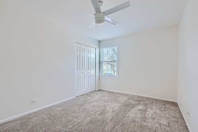 spare room featuring carpet floors and ceiling fan